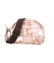 The Bed Stu Abundance is a small, dome-shaped sling bag with a light brown and white checkered patchwork design, featuring a wide dark brown adjustable strap and visible zipper for hands-free convenience.