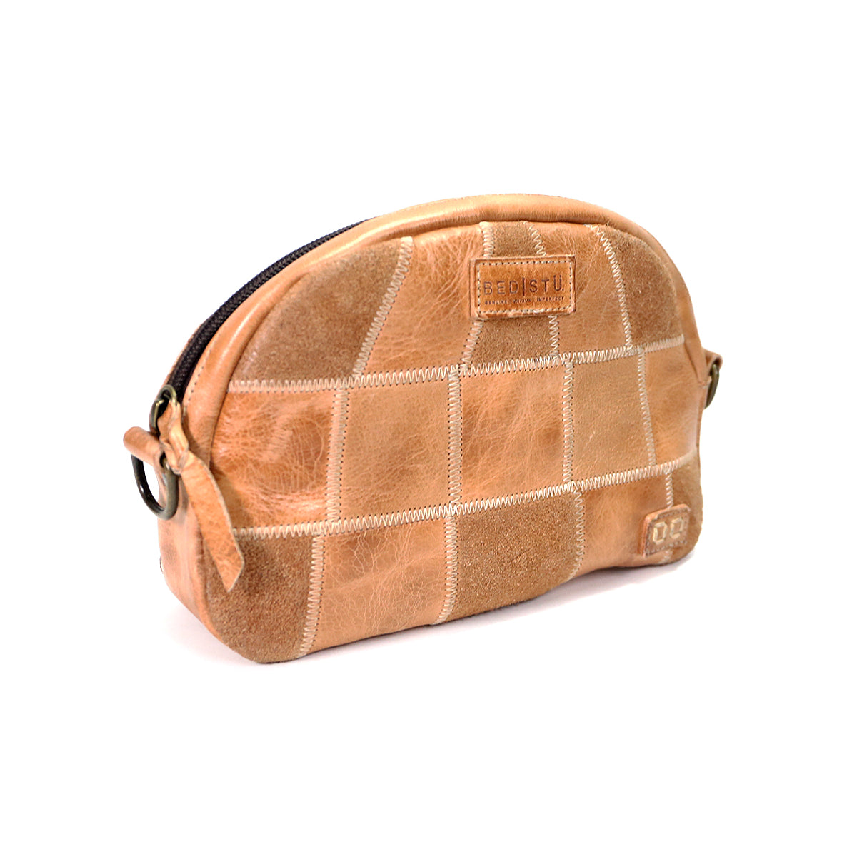 A light brown leather Abundance toiletry sling bag with a quilted design and Bed Stu logo, isolated on a white background.