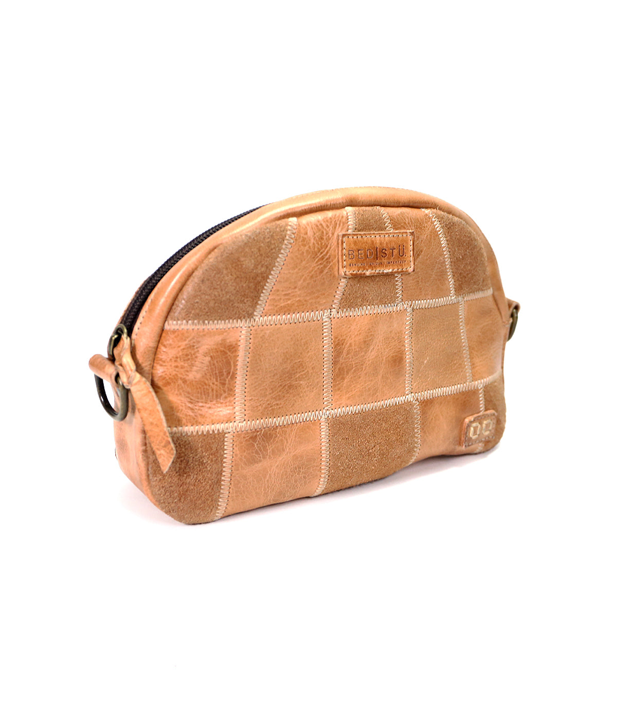 A light brown leather Abundance toiletry sling bag with a quilted design and Bed Stu logo, isolated on a white background.