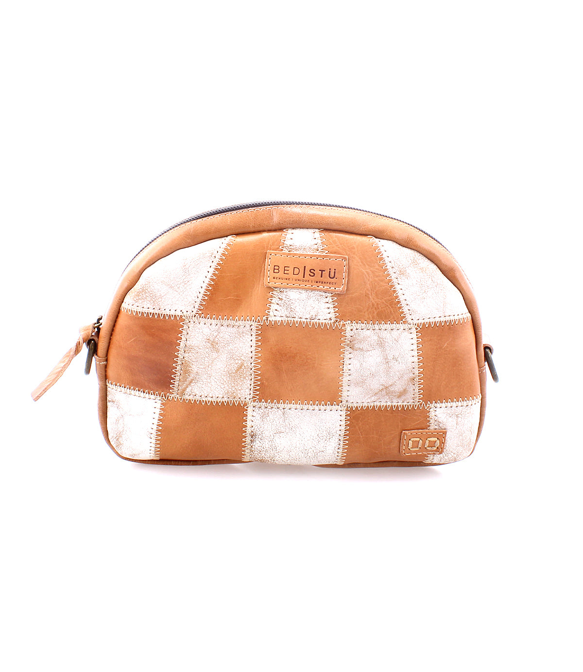 Brown and white leather patchwork sling bag with a zipper, branded "Abundance by Bed Stu" on a central patch, isolated on a white background.