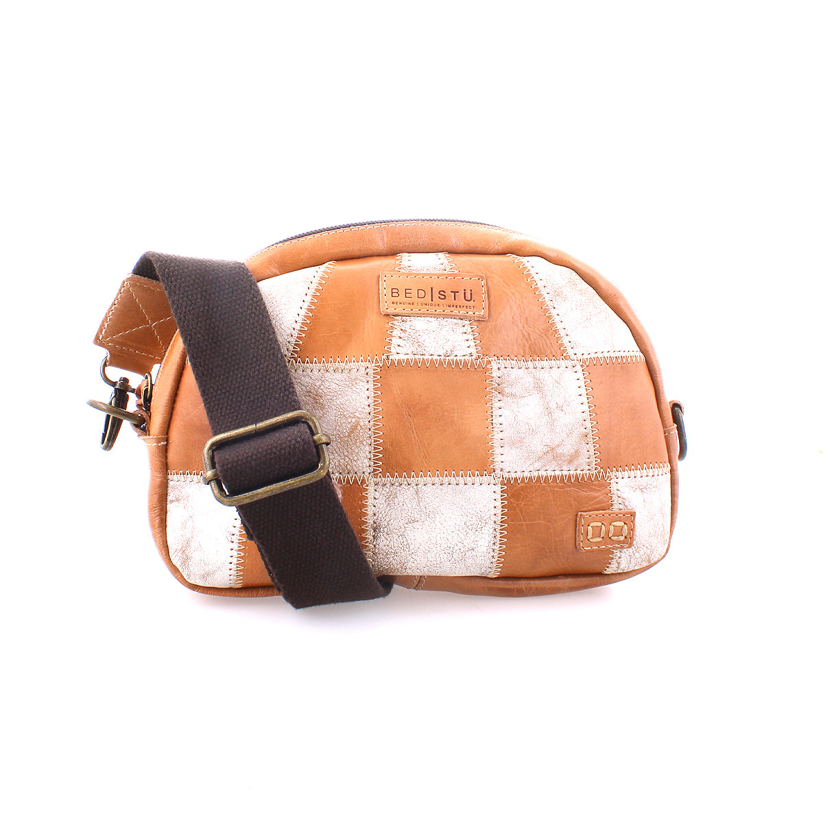 A patchwork leather sling bag with a brown adjustable strap, featuring embossed Bed Stu branding, displayed on a white background.