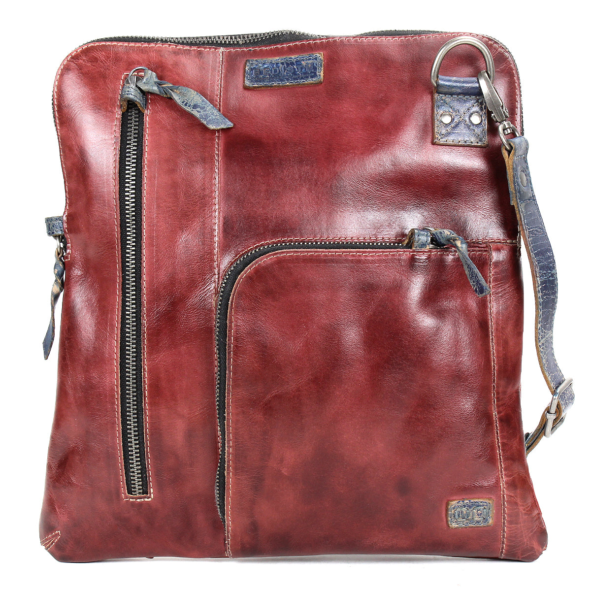 The Bed Stu Aiken is a square-shaped brown leather convertible crossbody bag with multiple zippered compartments, an adjustable strap, and a detachable design for versatile styling.