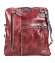 The Bed Stu Aiken is a square-shaped brown leather convertible crossbody bag with multiple zippered compartments, an adjustable strap, and a detachable design for versatile styling.