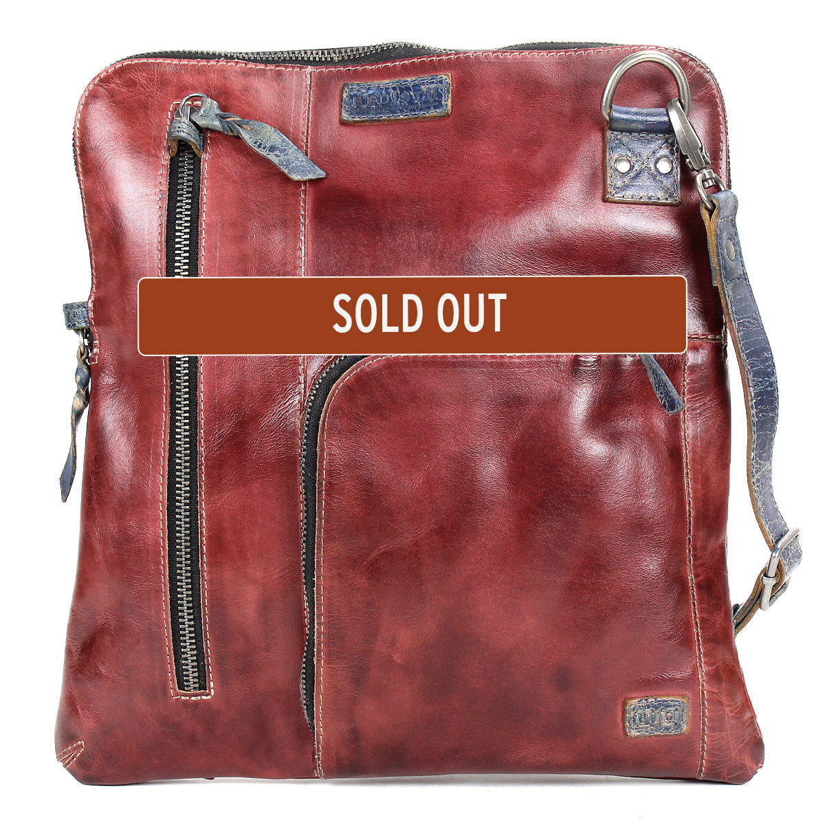 The Bed Stu Aiken is a brown leather convertible crossbody bag with multiple zippered pockets, an adjustable strap, and a bold "SOLD OUT" label across the front.