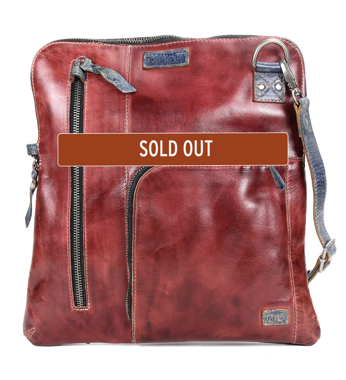 Bed|Stü’s Aiken crossbody bag features square shaping, full-grain reddish-brown leather, convenient zipper closures, and a patchwork adjustable strap. A "SOLD OUT" label is displayed across the center.