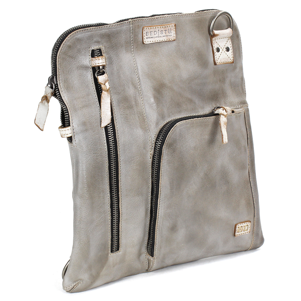 The Bed Stu Aiken is a square, grey leather convertible crossbody bag featuring beige accents, an adjustable strap, and multiple zippered compartments, displayed standing upright at an angle.