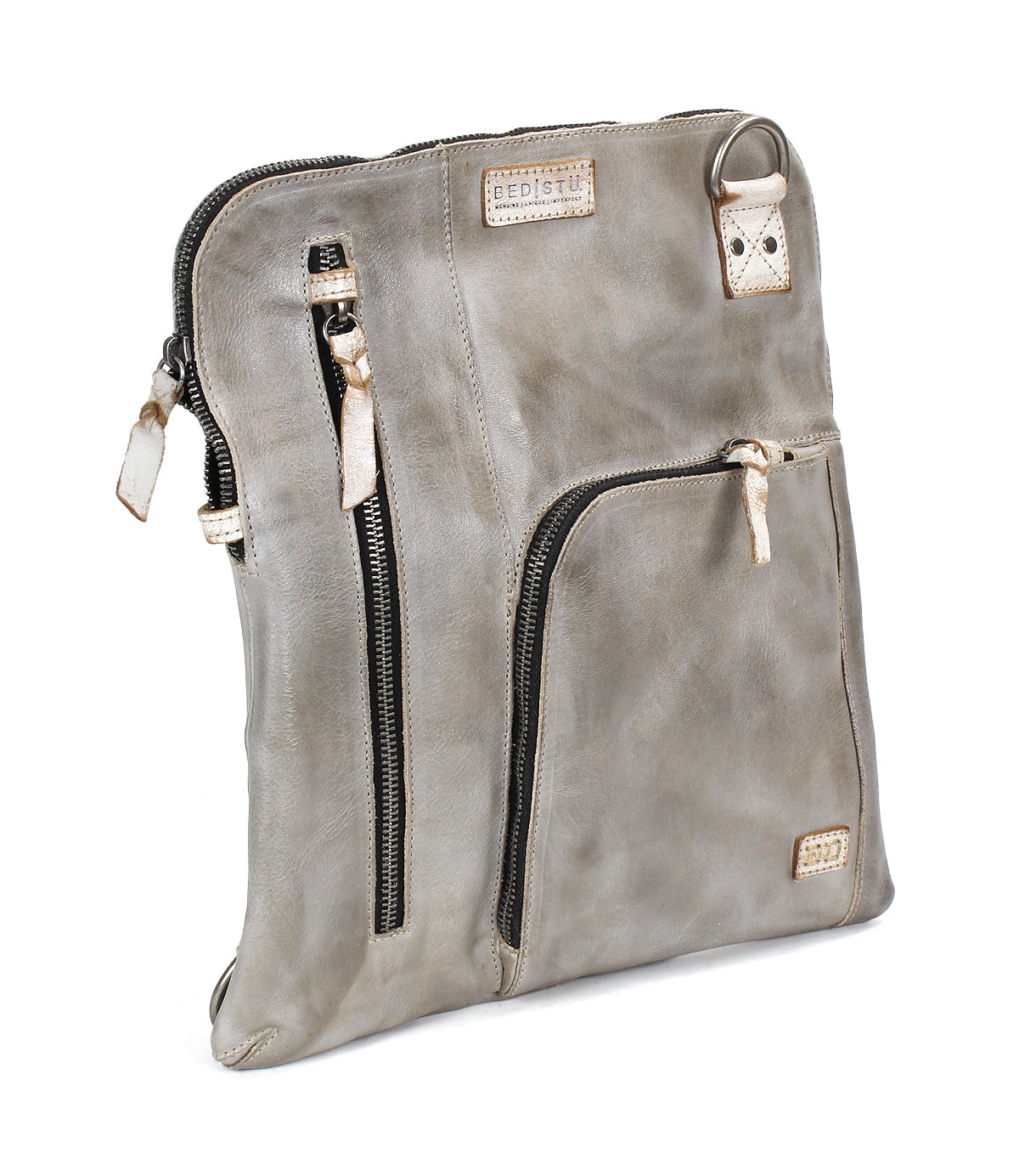 The Bed Stu Aiken is a square, grey leather convertible crossbody bag featuring beige accents, an adjustable strap, and multiple zippered compartments, displayed standing upright at an angle.