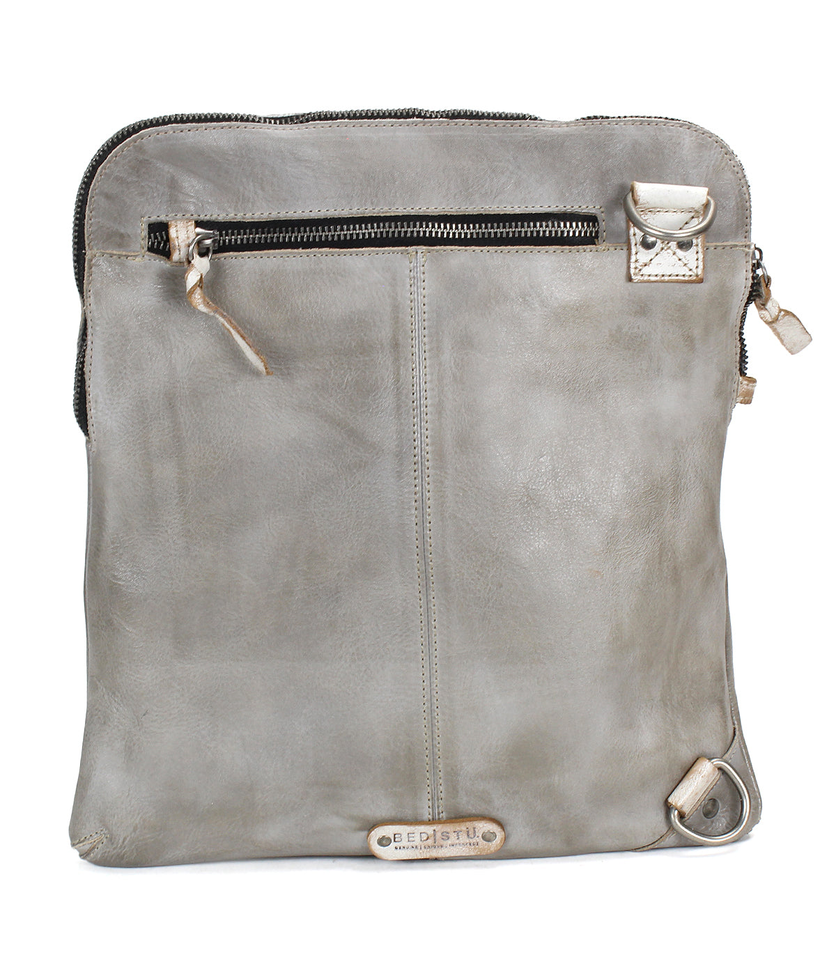 The Bed Stu Aiken is a rectangular grey leather shoulder bag with a top zipper, front zip pocket, metal hardware, adjustable strap for versatile wear, and a small logo tag near the bottom.