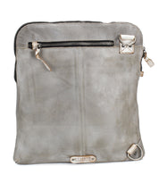 The Bed Stu Aiken is a rectangular grey leather shoulder bag with a top zipper, front zip pocket, metal hardware, adjustable strap for versatile wear, and a small logo tag near the bottom.
