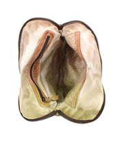 The Aiken by Bed Stu is a distressed, open leather bag with an adjustable strap. It reveals an empty interior with a vintage zipper pocket, highlighting its age and use.