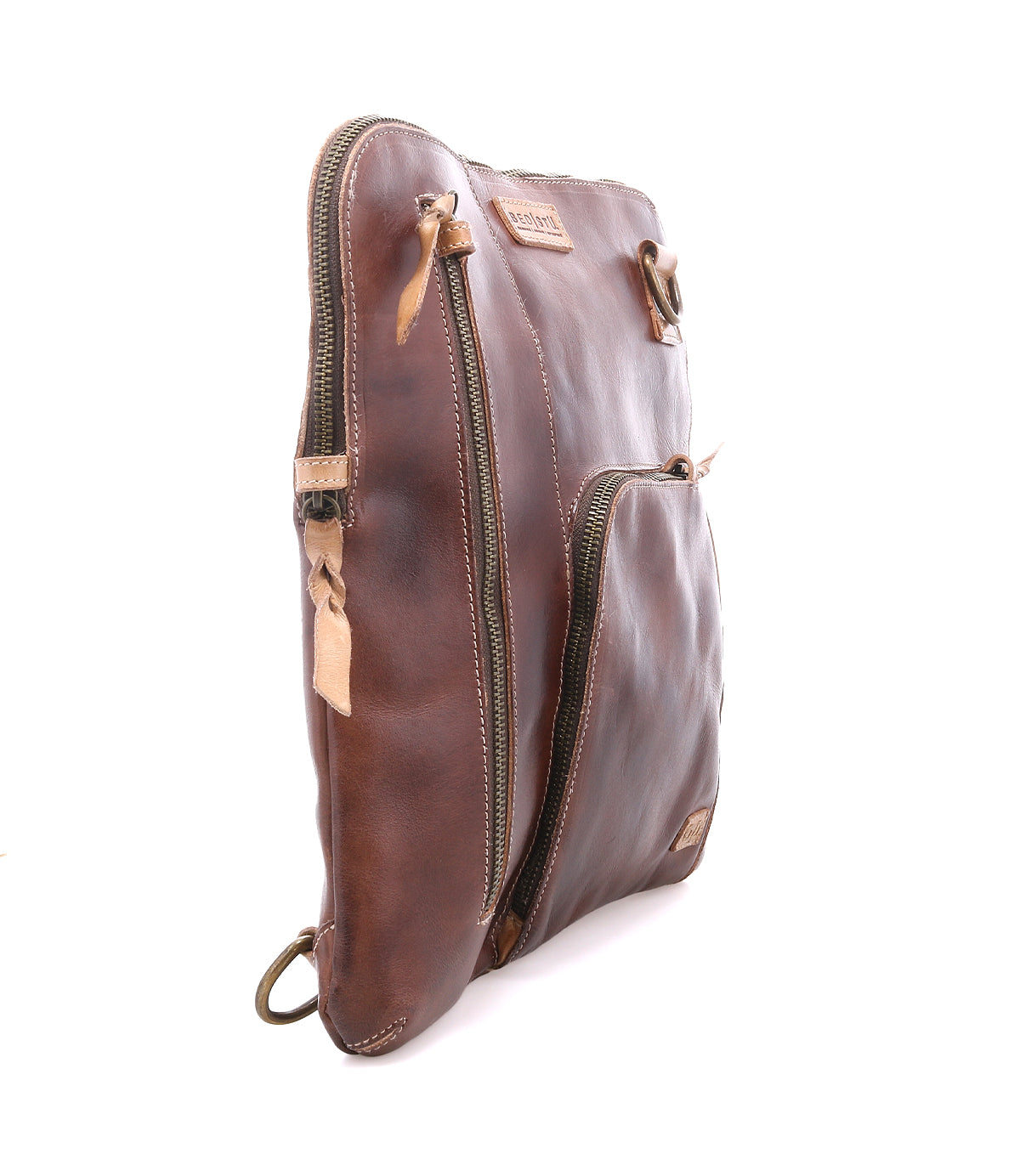 The Bed Stu Aiken is a brown full-grain leather pouch featuring two zippered compartments, tan pull tabs, and a ring attachment on the bottom corner, shown against a white background.