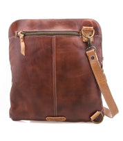 The Bed Stu Aiken is a brown full-grain leather crossbody bag featuring a front zipper pocket, adjustable strap, and visible stitching details.