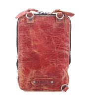 The Bed Stu Alelike is a compact leather crossbody in brown with visible creases, metal rings, a top zipper, and a front leather patch—ideal for everyday use and light travelers.