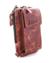 The Bed Stu Alelike is a compact brown pouch made of distressed premium leather, featuring a front flap pocket, zipper compartment, and visible stitching, shown standing upright on a white background.