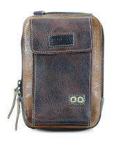 A weathered brown leather pouch with a rectangular shape, zippered closure, front pocket with button detail, and brand tag on the flap. Crafted from premium leather, it offers daily functionality and features two leather zipper pull tabs. The Alelike by Bed Stu combines style and practicality seamlessly.