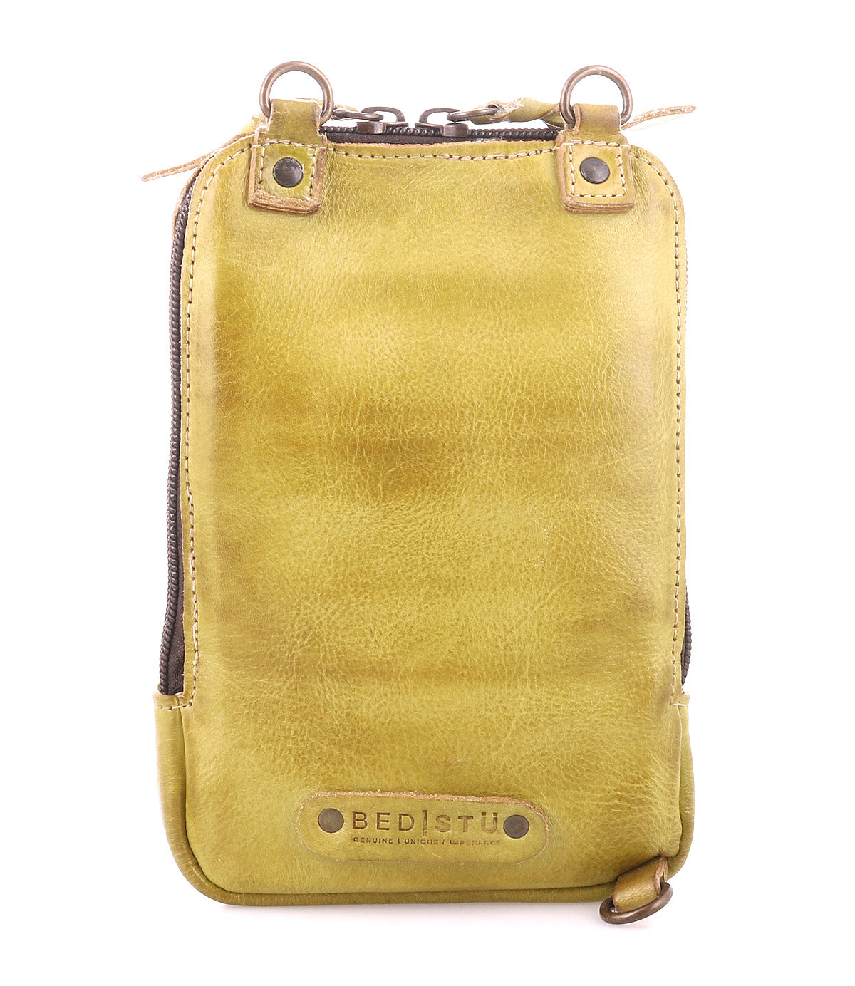 The Alelike by Bed Stu is a stylish yellow leather bag with a zippered top and brown metal rings, crafted from premium leather. It elegantly functions as a chic crossbody phone holder, with the brand name embossed at the bottom.