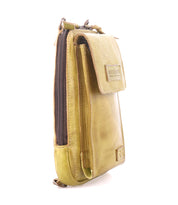 A small, stylish rectangular crossbody phone holder by Bed Stu, named Alelike, features olive green leather with a side view showing its flap closure and zipper.