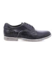 The Bed Stu Anchiano is a black distressed leather oxford shoe with visible stitching and a scuffed, flexible sole, shown in profile against a white background.