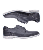 The Bed Stu Anchiano shoes are black distressed leather oxfords featuring white stitching and worn white soles, shown side by side on a white background.