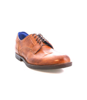 The Bed Stu Anchiano is a single brown leather oxford-style lace-up dress shoe with black laces and a dark, flexible sole, shown against a white background.