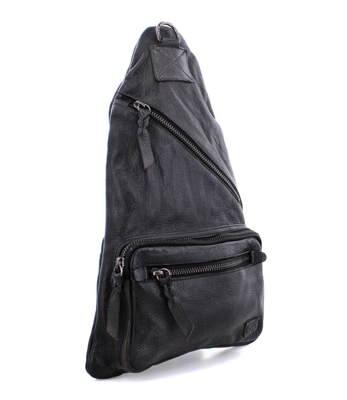 The Andie by Bed Stu is a black, triangular-shaped leather sling bag featuring multiple zippered compartments and an adjustable strap, offering practical functionality for everyday use as a versatile accessory.