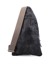 Side view of the Andie shoulder bag by Bed Stu, featuring black leather paired with a beige adjustable strap, embodying a blend of fashion and function as a versatile dual-gender accessory.