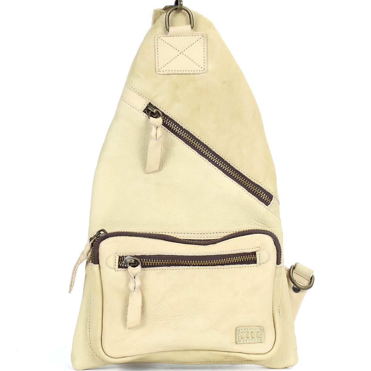 The Andie by Bed Stu is a versatile beige triangular leather sling bag featuring two zippered pockets and an adjustable strap, making it an ideal practical accessory for any outing.