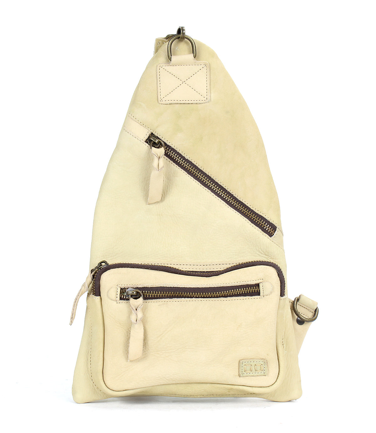 The Andie by Bed Stu is a versatile beige triangular leather sling bag featuring two zippered pockets and an adjustable strap, making it an ideal practical accessory for any outing.