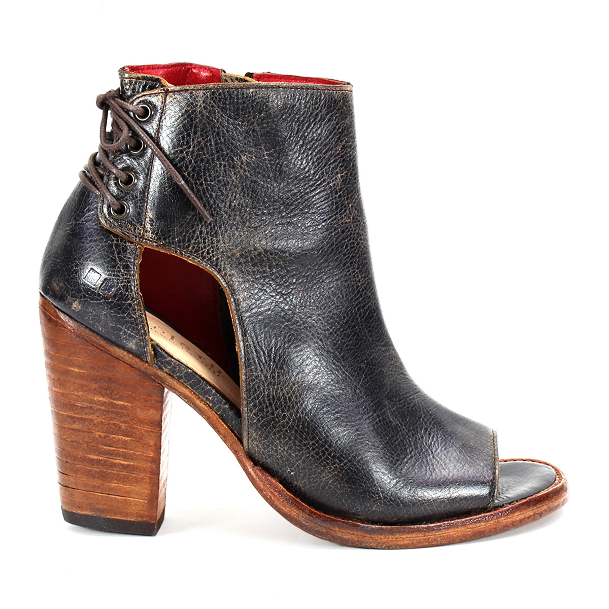 The Angelique by Bed Stu is a black leather peep-toe ankle boot featuring cutout sides, back lacing, and a high stacked wooden heel—an elegant transitional style for any season.