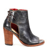 A women's black leather ankle boot with elegant back lacing and a wooden heel, like the Angelique II from Bed Stu.
