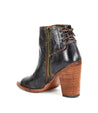 A black leather Angelique II ankle boot by Bed Stu with a wooden heel and elegant back lacing.