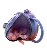 A leather Bed Stu Arenfield crossbody bag with an open zipper displaying an empty interior.