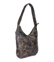 The Bed Stu Argus is a distressed brown handcrafted leather shoulder bag featuring a wide strap, front zippered pocket, and two exterior slip pockets.