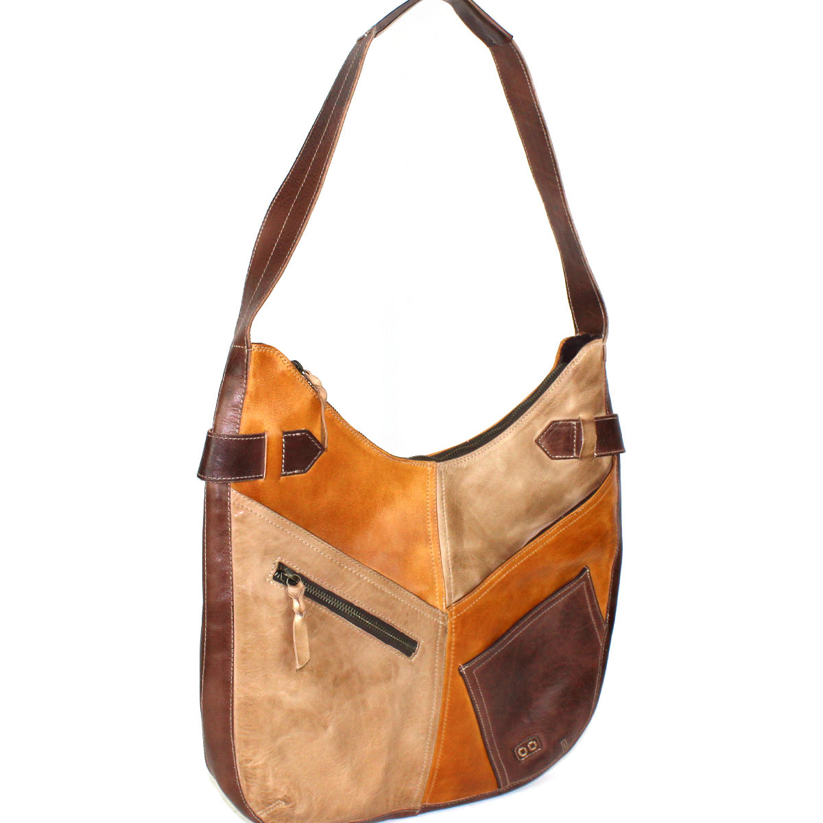 The Bed Stu Argus is a patchwork leather bag featuring oversized front pockets—a zippered pocket and a small stitched pocket—and a two-tone brown adjustable strap.