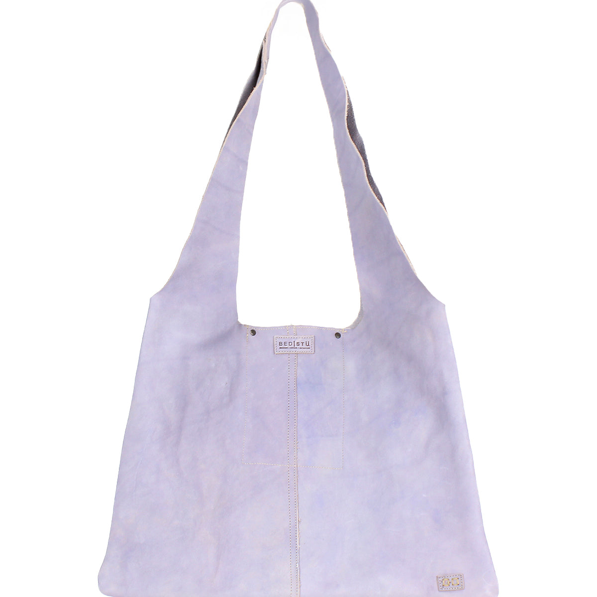 The Ariel II by Bed Stu is a light lavender shoulder bag with two long straps and a label near the top, offering a minimalist tote style. It has a spacious main compartment, ideal for carrying essentials in its lightweight design.