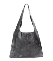 The Ariel II by Bed Stu is a black leather shoulder bag featuring a spacious compartment, wide strap, and sleek, minimalist design.
