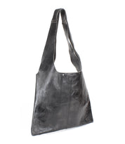 The Ariel II by Bed Stu is a lightweight black leather tote with long handles and a minimalist design. Featuring a small brand logo near the top, it pairs sleek looks with a spacious compartment for all your essentials.