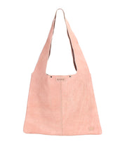 The Ariel II by Bed Stu is a pink suede tote bag with a wide single strap and visible stitching. Its minimalist charm is enhanced by a spacious main compartment, while subtle branding is achieved through an embossed small logo at the bottom right corner.