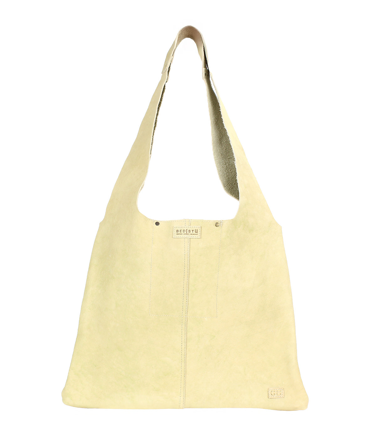 The Ariel II by Bed Stu is a beige suede shoulder bag with a wide strap, subtle stitching, and a small logo near the bottom, combining minimalism and functionality.