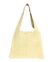 The Ariel II by Bed Stu is a beige suede shoulder bag with a wide strap, subtle stitching, and a small logo near the bottom, combining minimalism and functionality.