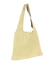 The Ariel II by Bed Stu is a beige suede handbag with a wide shoulder strap and minimalist design, featuring a small label on the front. Its spacious main compartment offers a seamless blend of style and practicality.