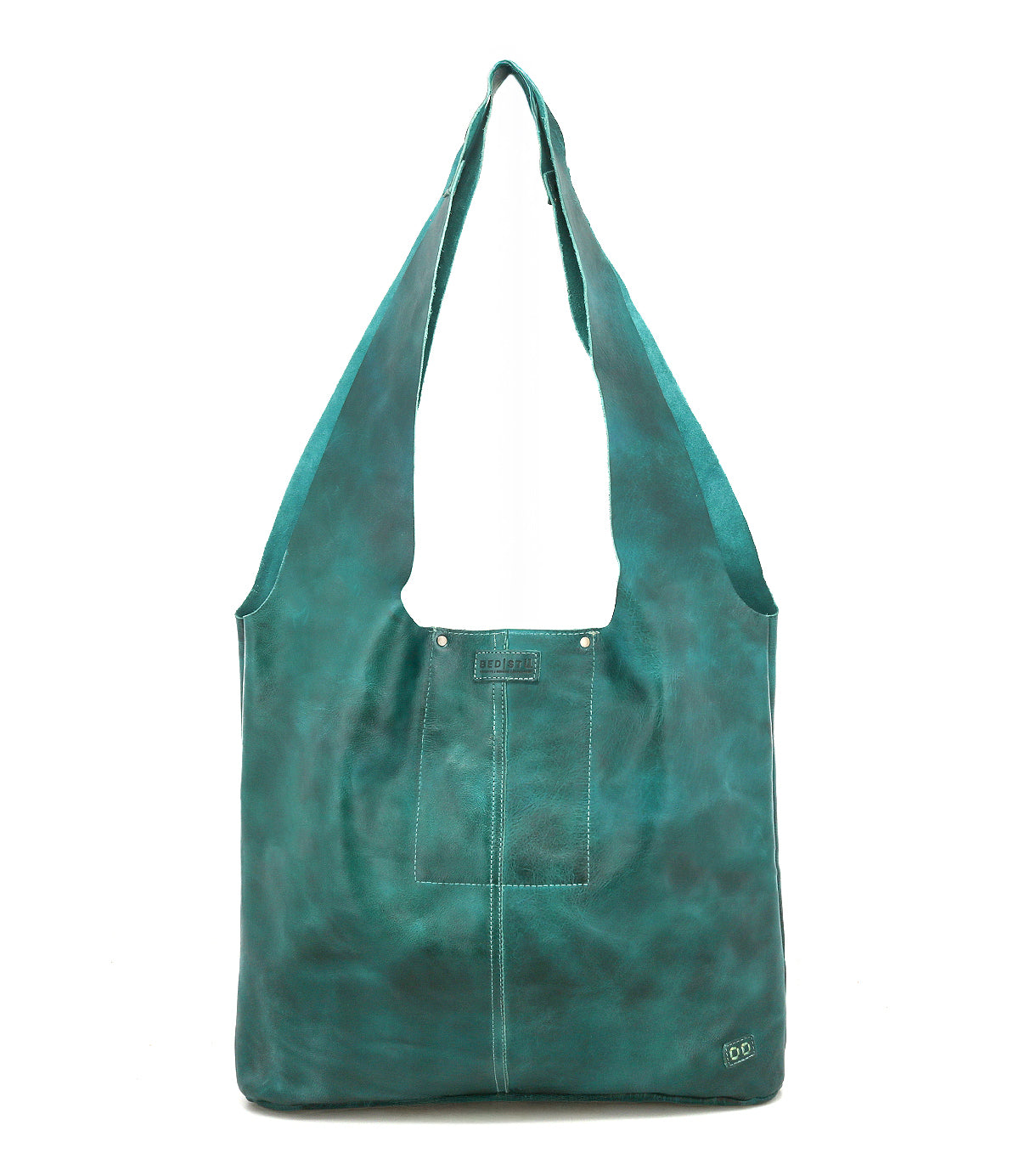 The Ariel Max by Bed Stu is a teal artisanal bag with a front pocket and wide straps, crafted from hand-finished leather and displayed upright against a white background.