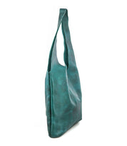 The Ariel Max by Bed Stu is a teal, slouchy oversized tote bag in hand-finished leather with a single wide strap, shown upright against a white background.