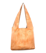 The Ariel Max by Bed Stu is a large, hand-finished leather shoulder bag with a wide strap, front pocket, and visible stitching, shown upright on a white background—an artisanal everyday accessory.