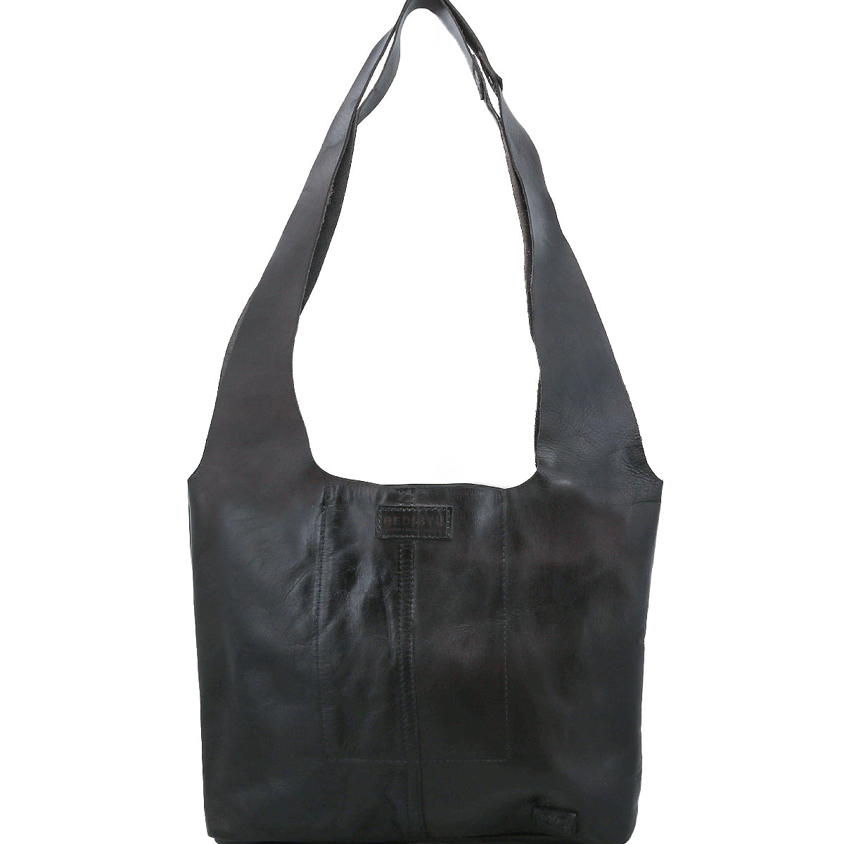 The Ariel Mid by Bed Stu is a black artisanal leather bag with wide straps, a rectangular shape, visible stitching, magnetic closure, and an embossed logo patch on the front—ideal for everyday use.