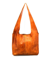 The Bed Stu Ariel Mid is a large, artisanal brown leather bag with a wide strap, magnetic closure, and two square front pockets—designed for everyday use and shown against a white background.