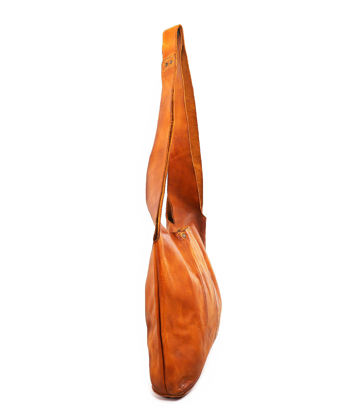 The Bed Stu Ariel Mid is a brown artisanal leather bag with a long, wide strap and magnetic closure, shown from the side on a white background—perfect for everyday function.