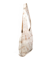 A side view of the Bed Stu Ariel Mid—a white and light brown tie-dye artisanal leather bag with a wide strap, magnetic closure, and a slouchy, casual design for everyday use.