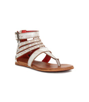 The Bed Stu Artemis II is a flat gladiator sandal with metallic leather straps, a toe loop, an ankle buckle, and a brown sole.