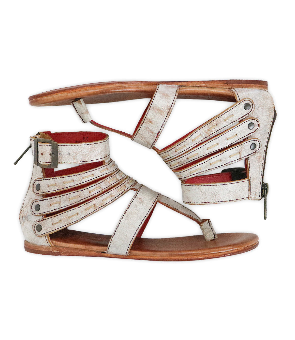 The Bed Stu Artemis II is a pair of flat gladiator sandals featuring strappy open-toe leather straps, metal rivets, and buckles, shown in a side profile view.